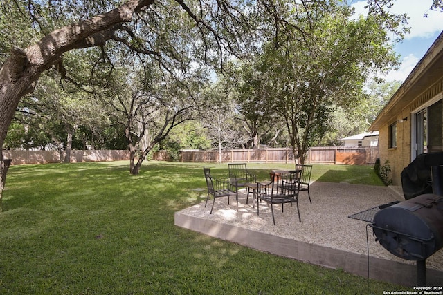 view of yard featuring a patio area and a fenced backyard