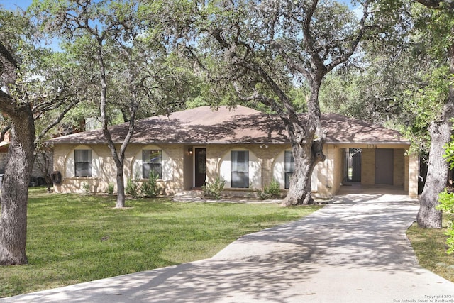 single story home featuring an attached carport, a front yard, and concrete driveway