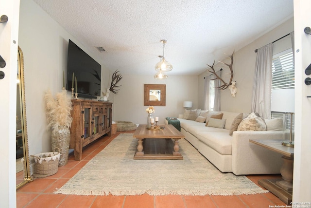 living area featuring a wealth of natural light, a textured ceiling, and visible vents