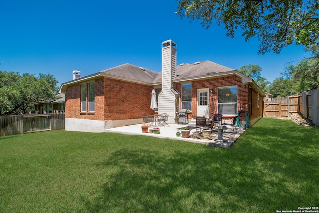 1106 Crystal Spg, San Antonio, TX 78258 - rear view of house featuring brick siding, a lawn, a chimney, and a fenced backyard