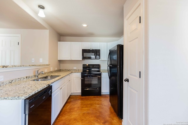 kitchen with white cabinets, finished concrete floors, a sink, and black appliances