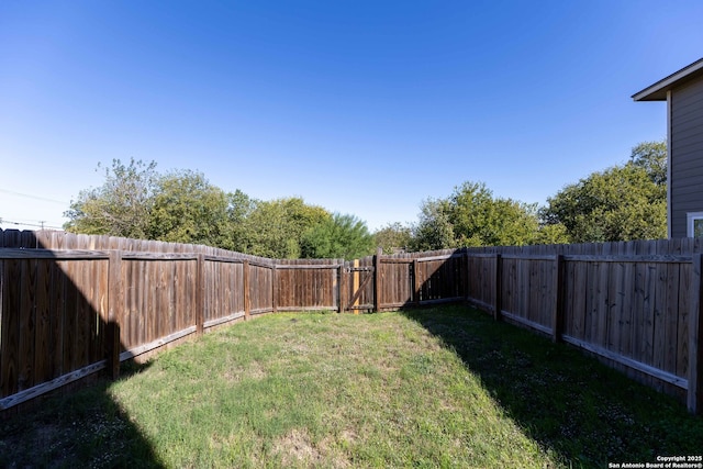 view of yard with a fenced backyard