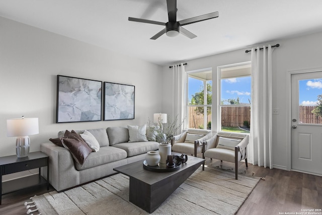 living area with a ceiling fan and wood finished floors