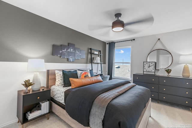 bedroom featuring light colored carpet and ceiling fan