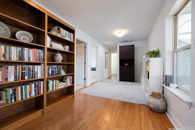 hallway with baseboards and light wood-style floors