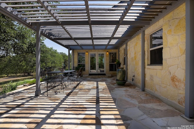 view of patio with a pergola, outdoor dining area, and french doors