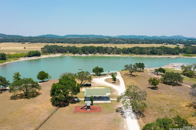 birds eye view of property with a water and mountain view