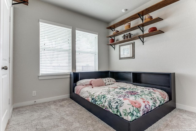 carpeted bedroom with baseboards