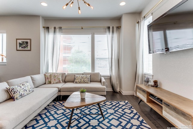 living room featuring an inviting chandelier, dark wood-style floors, recessed lighting, and a healthy amount of sunlight