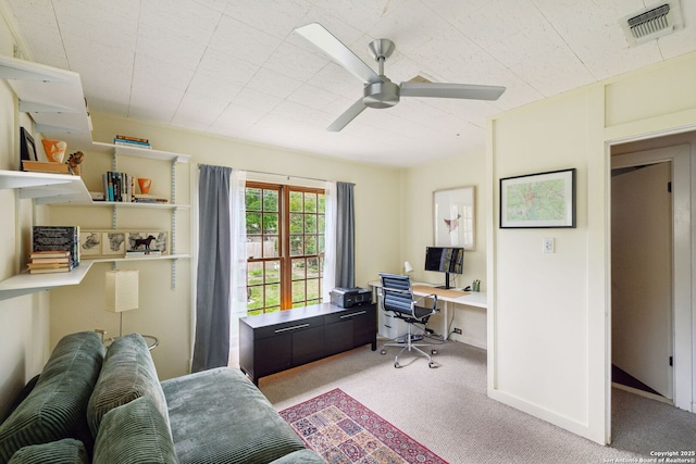 home office featuring visible vents, carpet floors, and ceiling fan