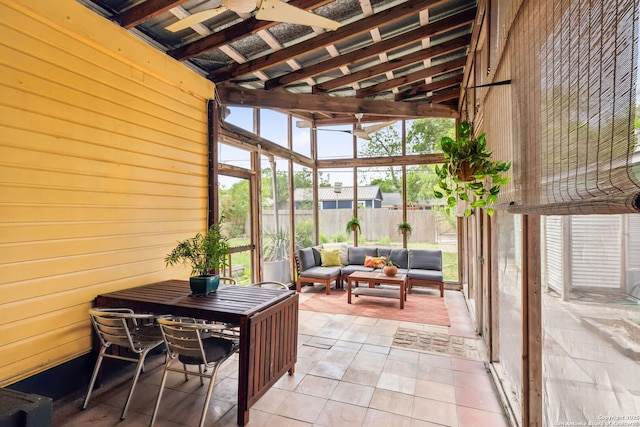 sunroom / solarium featuring a ceiling fan and an outdoor hangout area