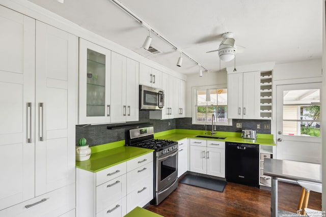 kitchen featuring a ceiling fan, a sink, appliances with stainless steel finishes, and tasteful backsplash