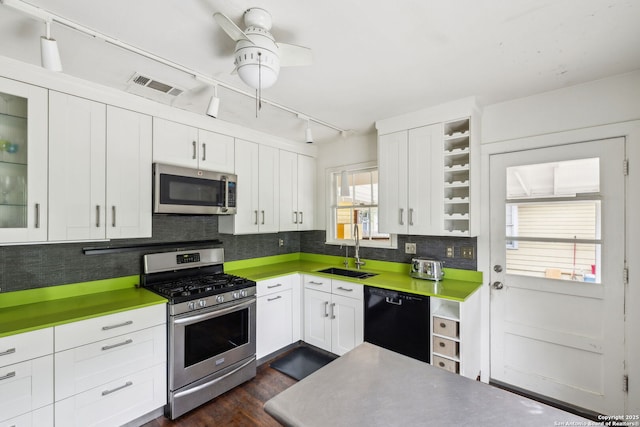 kitchen with white cabinetry, stainless steel appliances, visible vents, and a sink
