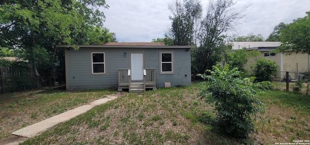 back of house featuring fence