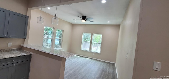 kitchen with a ceiling fan, wood finished floors, gray cabinets, light countertops, and recessed lighting