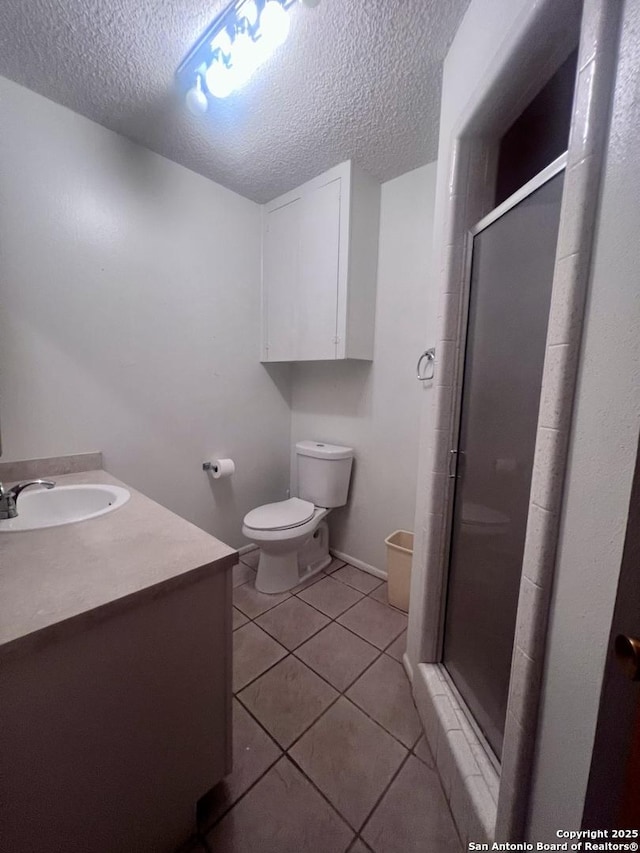 7 Sunrise, Pleasanton, TX 78064 - full bathroom featuring a textured ceiling, tile patterned flooring, a stall shower, and toilet