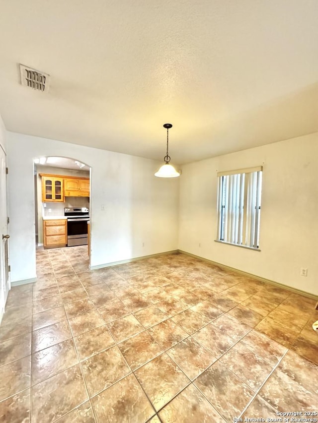 36 Leona Hts, Uvalde, TX 78801 - unfurnished room featuring arched walkways and light tile patterned floors