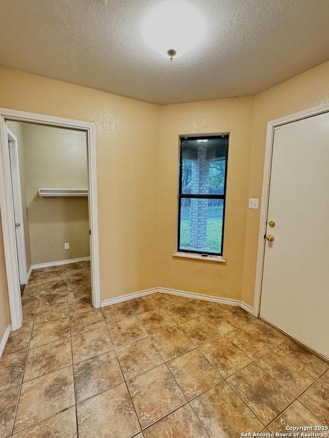 36 Leona Hts, Uvalde, TX 78801 - unfurnished room featuring a textured ceiling and light tile patterned floors