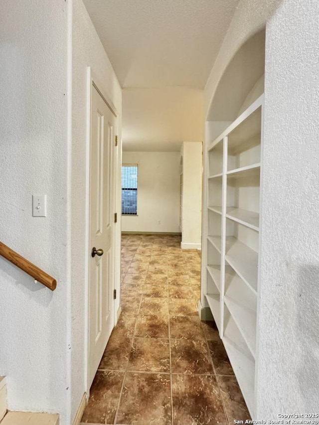 36 Leona Hts, Uvalde, TX 78801 - corridor with a textured wall and baseboards
