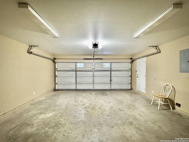36 Leona Hts, Uvalde, TX 78801 - garage featuring electric panel, a garage door opener, and baseboards