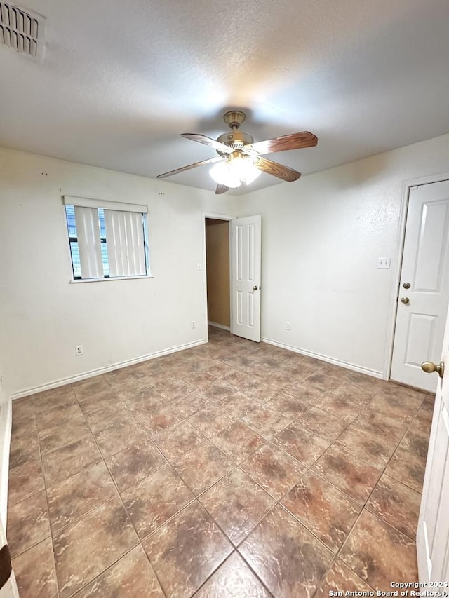 36 Leona Hts, Uvalde, TX 78801 - spare room featuring a ceiling fan and baseboards