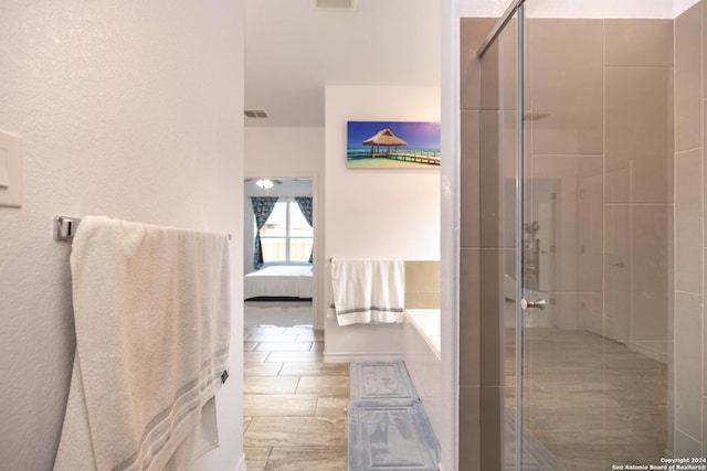 ensuite bathroom with a shower stall, ensuite bath, a garden tub, and visible vents