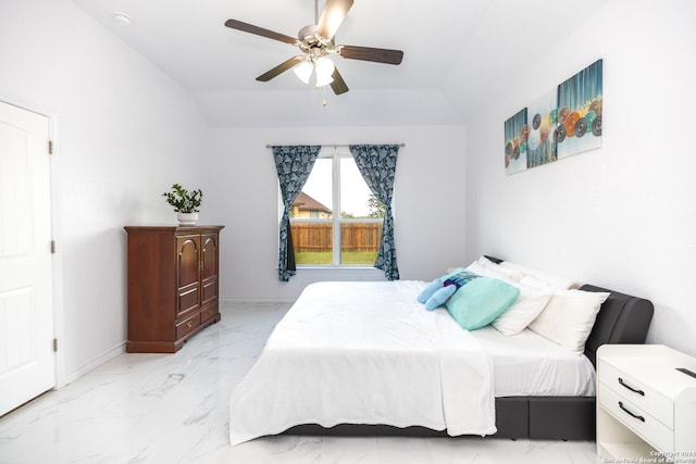bedroom featuring lofted ceiling, marble finish floor, baseboards, and a ceiling fan