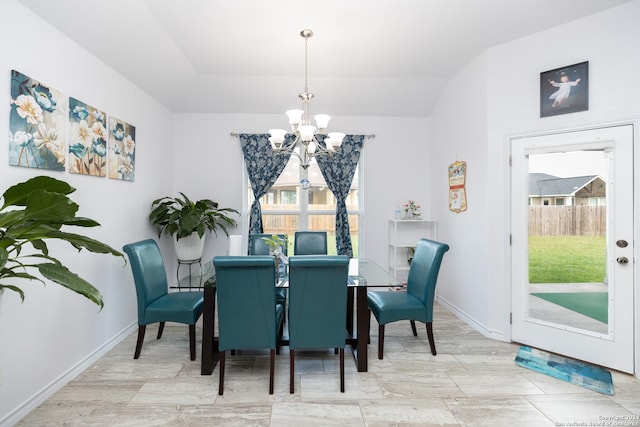 dining space with baseboards and a chandelier