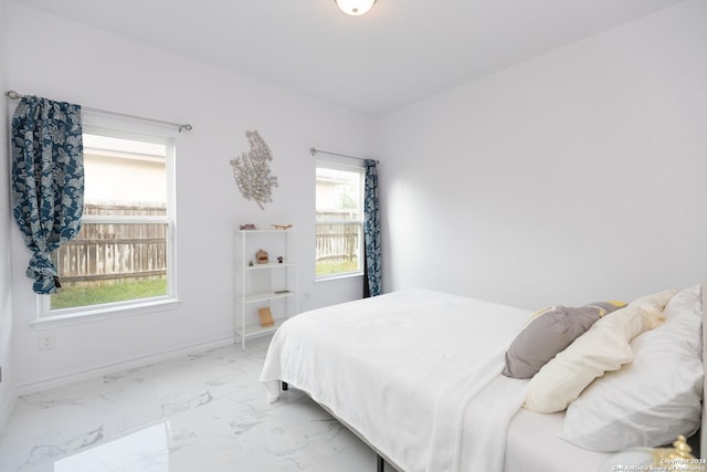 bedroom with marble finish floor and baseboards