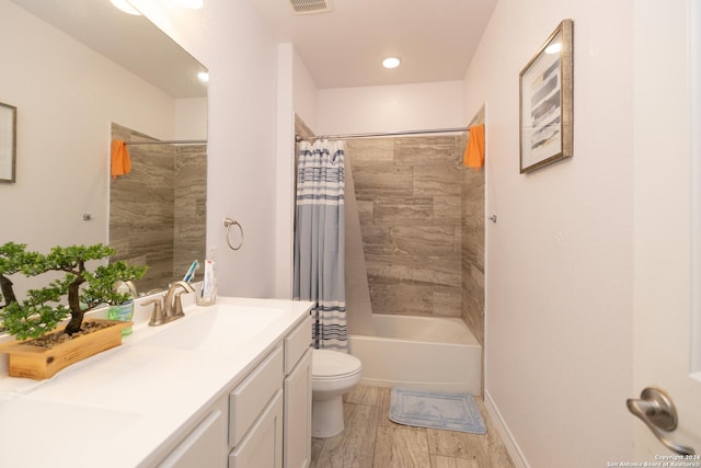 full bathroom with wood finished floors, vanity, shower / bathtub combination with curtain, toilet, and visible vents