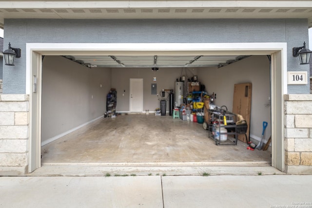 garage featuring concrete driveway, gas water heater, and electric panel