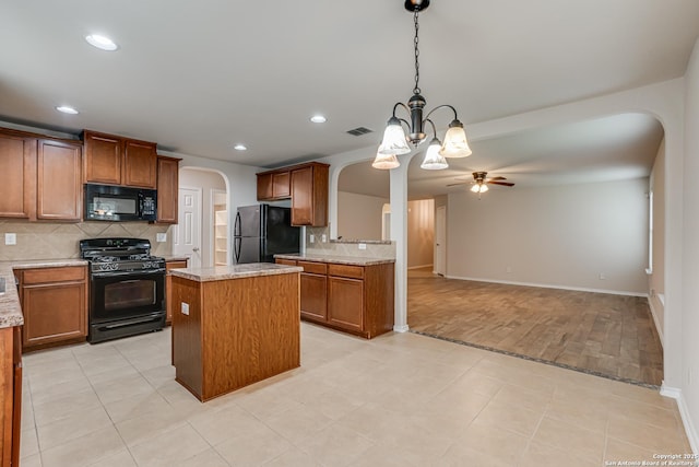 342 Perch Horizon, San Antonio, TX 78253 - kitchen featuring tasteful backsplash, ceiling fan with notable chandelier, black appliances, arched walkways, and visible vents