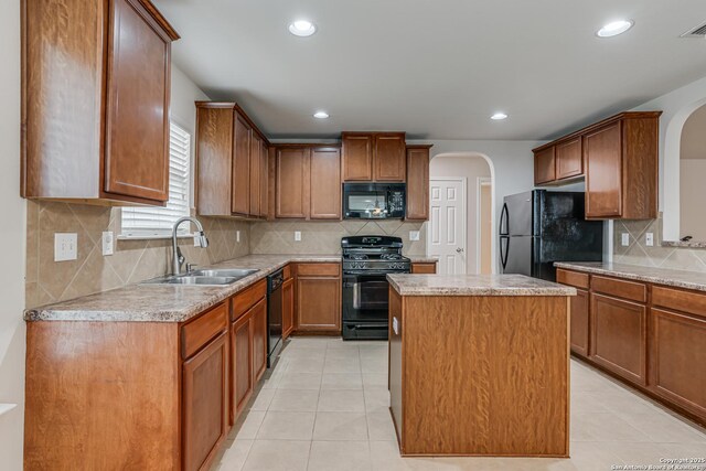 342 Perch Horizon, San Antonio, TX 78253 - kitchen featuring arched walkways, light tile patterned floors, a sink, and black appliances