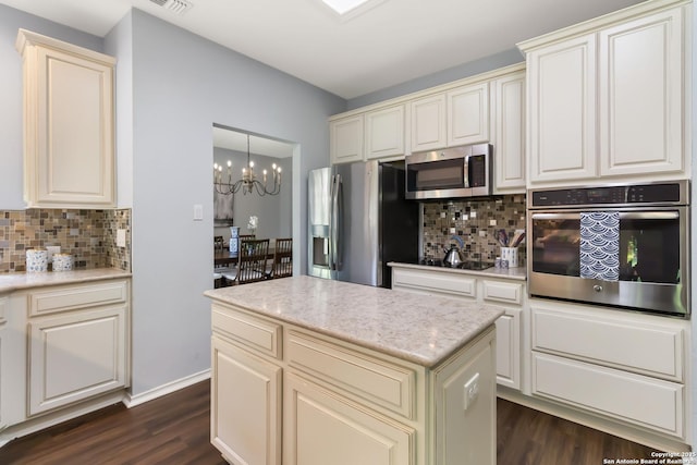 2527 Ashton Village, San Antonio, TX 78248 - kitchen featuring appliances with stainless steel finishes, dark wood-type flooring, backsplash, and a chandelier