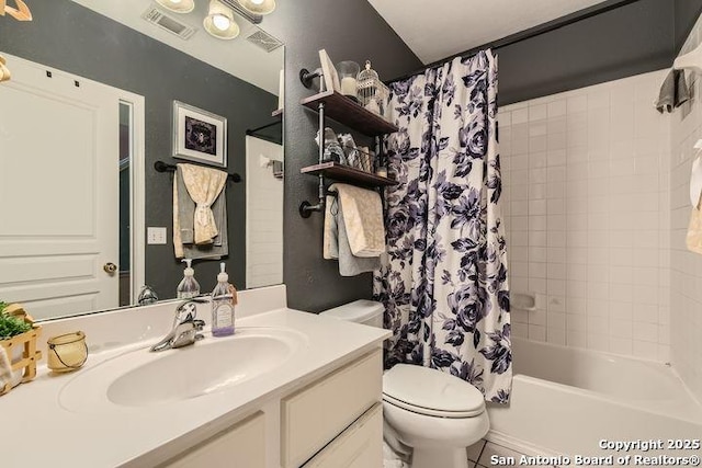 bathroom featuring vanity, shower / bath combo, toilet, and visible vents
