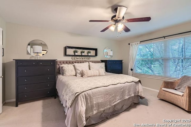 bedroom featuring baseboards, ceiling fan, and carpet