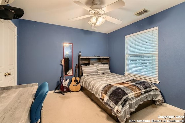 carpeted bedroom featuring visible vents, baseboards, and ceiling fan