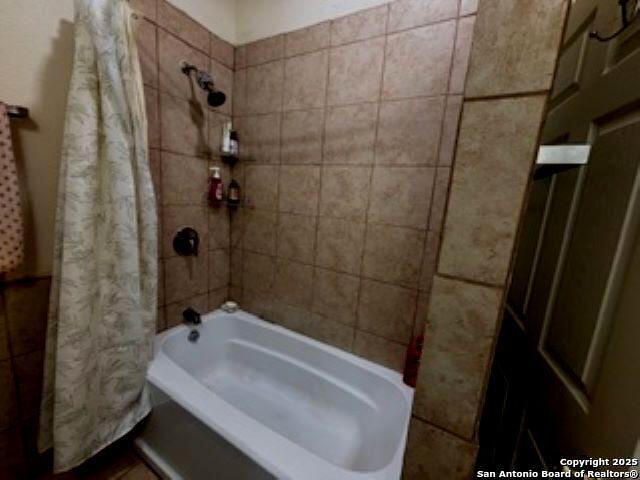 1121 N Oak, Pearsall, TX 78061 - bathroom with shower / bathtub combination with curtain