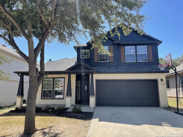 view of front of property with an attached garage, a shingled roof, and driveway