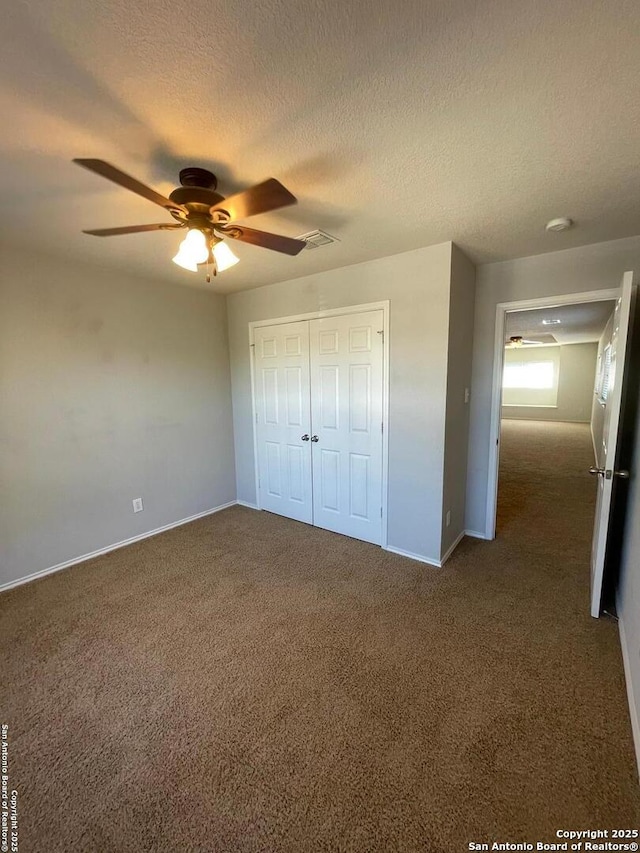 unfurnished bedroom with visible vents, baseboards, carpet, and a closet