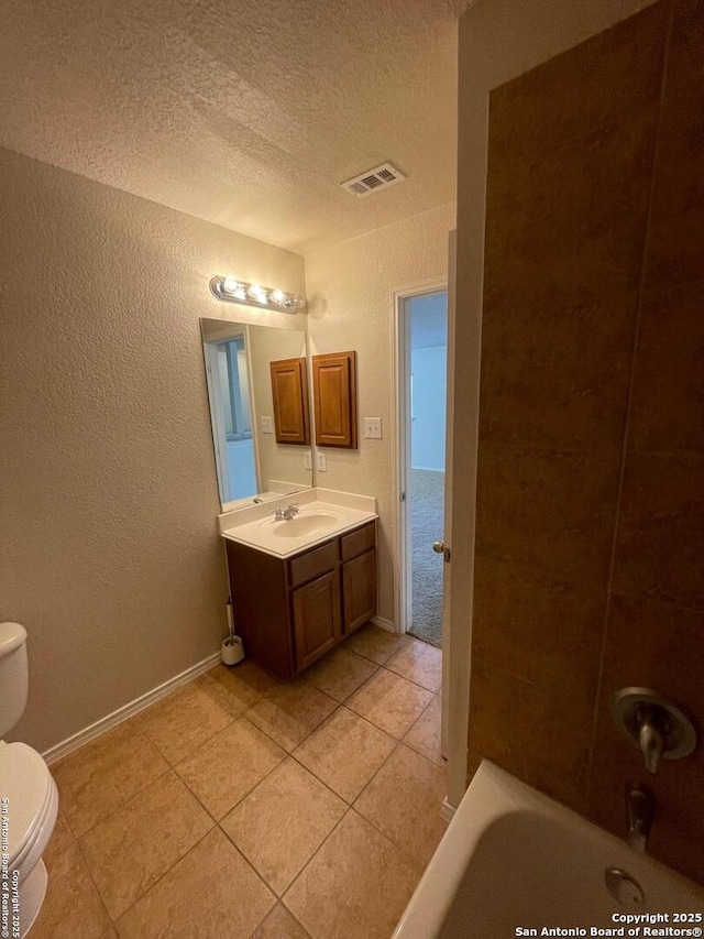 full bathroom featuring a textured ceiling, toilet, visible vents, tile patterned flooring, and vanity