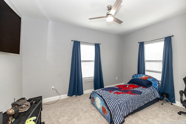 carpeted bedroom featuring a ceiling fan and baseboards