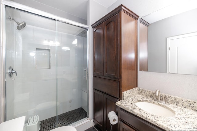 bathroom with a shower stall and vanity