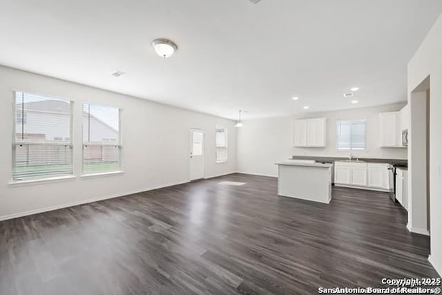11264 Long Rider, San Antonio, TX 78254 - unfurnished living room with dark wood finished floors, a sink, baseboards, and recessed lighting
