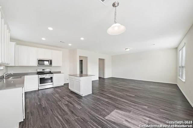 11264 Long Rider, San Antonio, TX 78254 - kitchen with appliances with stainless steel finishes, a sink, open floor plan, dark wood-style flooring, and white cabinetry