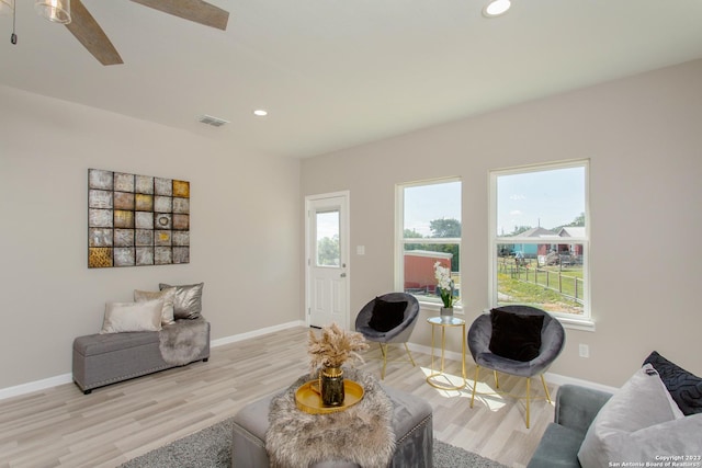 living room featuring recessed lighting, light wood-style floors, visible vents, and baseboards