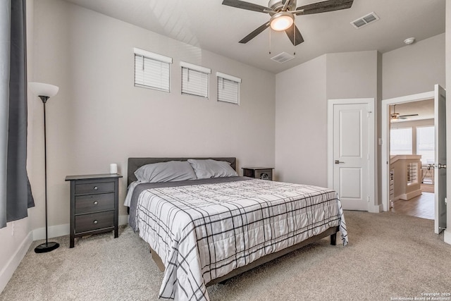 bedroom featuring baseboards, visible vents, and light colored carpet