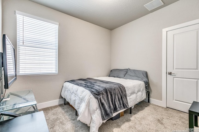 carpeted bedroom with baseboards and visible vents