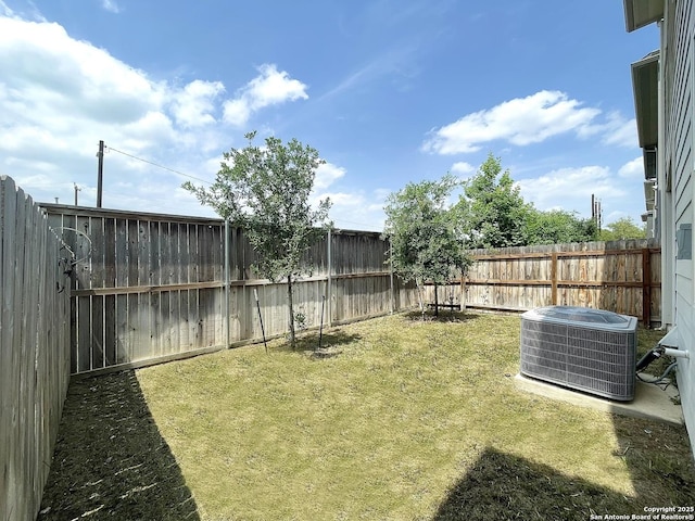 view of yard featuring central air condition unit and a fenced backyard