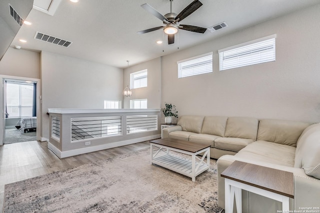 living room with wood finished floors, visible vents, recessed lighting, and ceiling fan